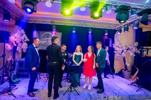 Ballroom dance performance with theatrical lighting and professional stage setup.