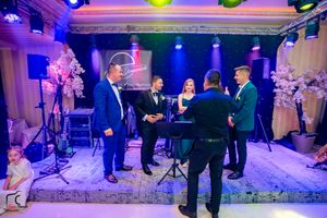 Wedding venue space with professional lighting rigs casting multicolored beams across the room.