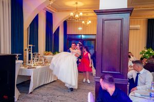 Luxurious banquet hall with chandelier and elegant decor prepared for a formal celebration.