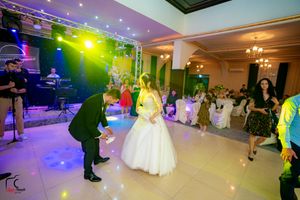 Spacious reception hall with dramatic lighting effects and elegant table settings.