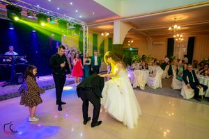 Large ballroom space with theatrical lighting and formal event setup.