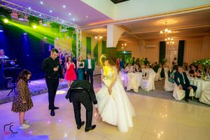 Elegant reception hall with dramatic lighting and spacious dance floor area.