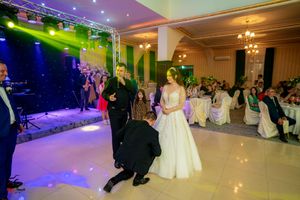 Wedding reception venue with colorful LED lighting and guests dancing on the dance floor.