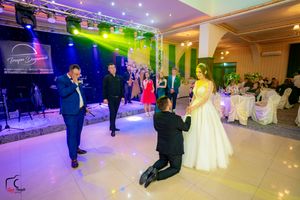 Banquet hall decorated with colorful LED lights for an evening wedding celebration.