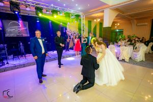 Wedding reception venue featuring dynamic lighting and guests enjoying the festivities.
