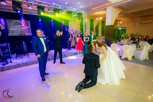 Wedding celebration in progress with dramatic lighting effects in an elegant venue.