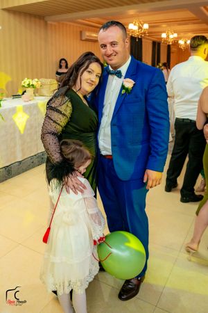 Dancers enjoying themselves at a wedding reception with balloons and decorative lighting.