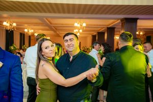 Wedding reception dance floor with colorful lighting and couples dancing.