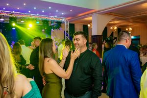 Dance floor with colorful lighting and guests dancing at an evening celebration.