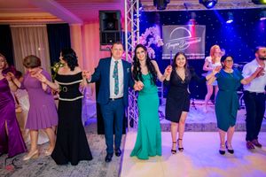 Evening dance party showing multiple couples dancing under professional stage lighting and truss system.