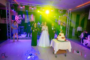 Wedding venue with colorful lighting effects and dance floor setup in panoramic view.