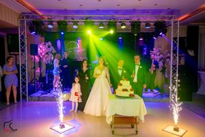 Wedding venue with sparkler fountains and multicolored lighting creating a festive atmosphere.