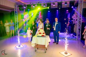 Wedding reception space featuring theatrical lighting and special effects creating a vibrant party atmosphere.