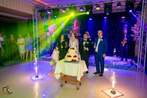 Modern wedding venue setup with professional stage lighting and special effects creating a dramatic ambiance.
