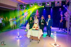 Luxurious wedding reception hall with dynamic lighting design and professional staging equipment.