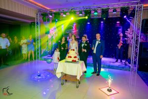 Wedding celebration space with elaborate lighting setup and professional staging creating a festive atmosphere.
