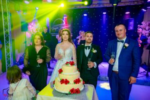 Elegant wedding celebration venue with dramatic lighting effects and professional staging elements.