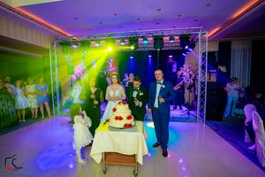 Modern wedding venue with purple and green lighting effects creating an atmospheric celebration space.