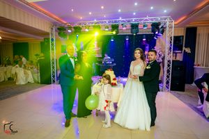 Wedding reception scene with dramatic lighting effects and elegant decor in a banquet hall.