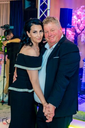 Couples sharing romantic dances at an elegant evening event with dramatic lighting and decor.