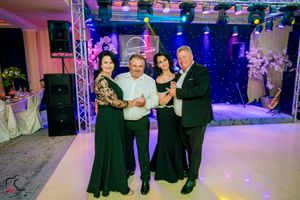 Couples dancing together at a formal event with professional lighting and stage setup.