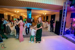 Ballroom dance celebration with colorful mood lighting and elegant decor.