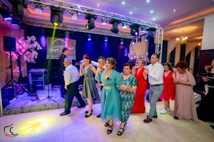 Dance party in a luxurious ballroom with professional lighting and entertainment setup.