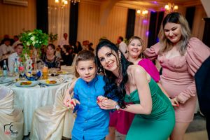 Celebration event in an elegant venue with round dining tables and festive atmosphere.
