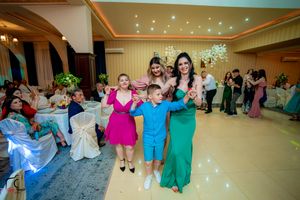 Panoramic view of a wedding reception dance floor with colorful lighting and festive atmosphere.