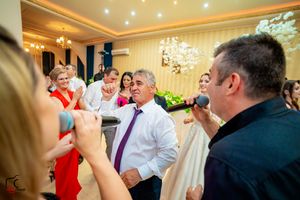 Energetic performers leading party entertainment at an indoor celebration with guests.