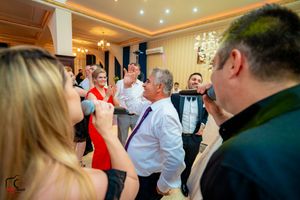 Animated party scene with performers and guests interacting during an indoor celebration.