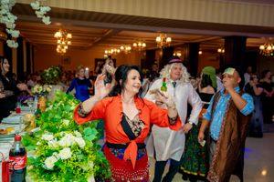 Festive indoor celebration with decorative lighting and white floral arrangements.