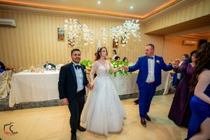 Elegant ballroom celebration with chandelier lighting and guests enjoying the festivities.