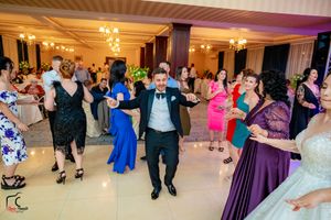 Elegant ballroom filled with dancing couples during a formal evening celebration.