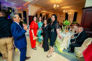 Wedding reception candid moments with guests mingling and celebrating in a decorated ballroom.