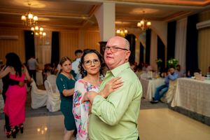 Couple sharing a tender dance moment at an elegant wedding reception.