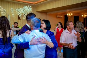 Couples slow dancing together during an intimate moment at a wedding reception.