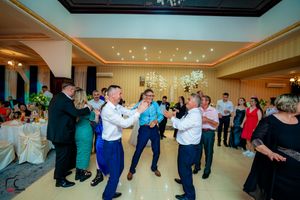 Guests performing choreographed dance moves at a lively wedding reception.