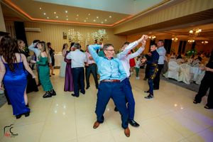 Guest showing off enthusiastic dance moves on the reception dance floor.