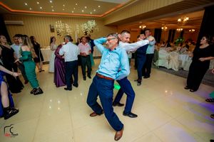 Two guests performing synchronized dance moves at a wedding celebration.
