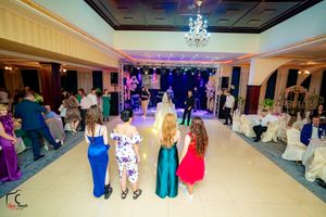 Overhead view of elegant wedding reception ballroom with chandelier and dance floor setup.