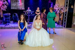 Wedding reception scene with formal attire and professional stage lighting setup.