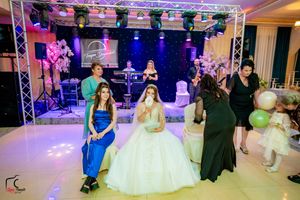 Wedding celebration with decorative lighting and balloons in an elegant reception venue.