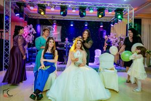 Wedding celebration with stage lighting, floral decorations and formal party attire.