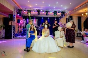 Wedding party gathering with professional lighting setup and elegant decorations.