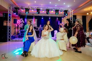 Event space with professional lighting rig and formal white decor for a special occasion.