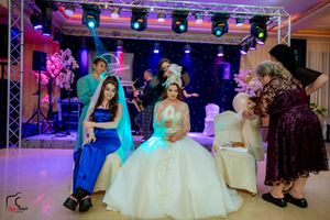 Elegant wedding reception venue decorated with colorful lighting and a starlit backdrop.