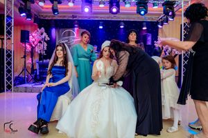 Wedding reception dance floor with colorful purple and blue lighting creating a festive party atmosphere.