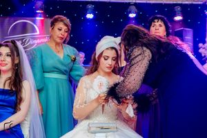 Elegant wedding reception with guests dancing under starry blue lighting effects.