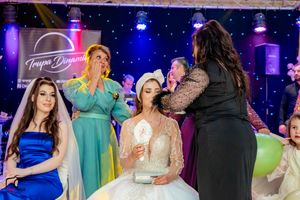 Wedding reception venue decorated with blue uplighting and guests enjoying the dance floor atmosphere.